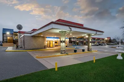 a building with a parking lot in front of it at Days Inn by Wyndham Perrysburg Toledo in Perrysburg