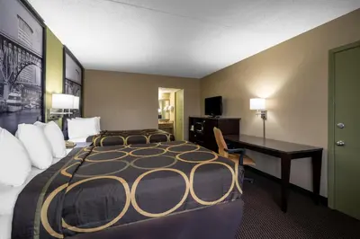 a hotel room with a large bed and a desk at Super 8 by Wyndham Perrysburg-Toledo in Perrysburg