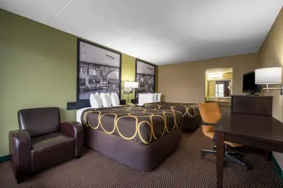 a hotel room with a bed and a desk and chair at Super 8 by Wyndham Perrysburg-Toledo in Perrysburg