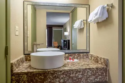 a bathroom with a large mirror and a sink at Super 8 by Wyndham Perrysburg-Toledo in Perrysburg