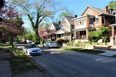 two cars parked on the street in front of houses at Modern 2BR near DT, 8min walk to Park&Conservatory in Columbus