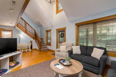 a living room with a couch and a table at Canadian Hemlock . Trailside Lodging in Millersburg