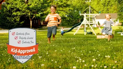 two children playing in a yard with a swing at Canadian Hemlock . Trailside Lodging in Millersburg