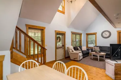 a living room with a couch and a table at Canadian Hemlock . Trailside Lodging in Millersburg