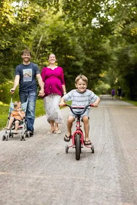 a man and a woman and a child riding a bike at Canadian Hemlock . Trailside Lodging in Millersburg