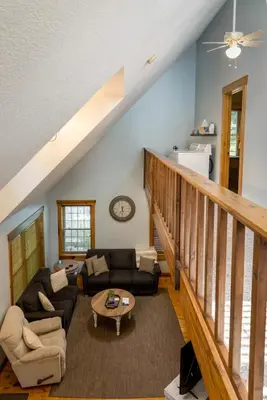 a living room with a couch and a table at Canadian Hemlock . Trailside Lodging in Millersburg