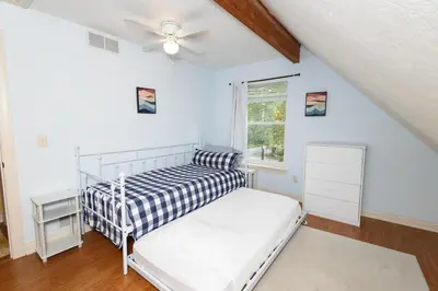 a bedroom with a bed and a ceiling fan at Home STEPS from Oberlin in Oberlin