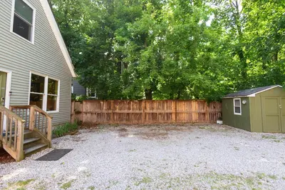 a backyard with a wooden fence and a shed at Home STEPS from Oberlin in Oberlin
