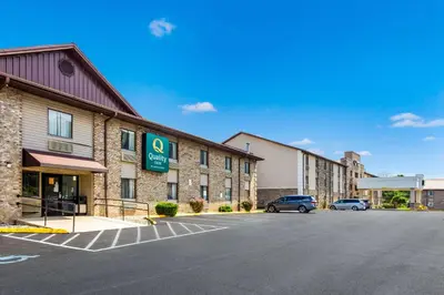 a hotel with cars parked in a parking lot at Quality Inn Charleston South in Charleston