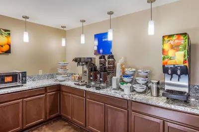 a coffee shop with a counter with a coffee maker at Quality Inn Charleston South in Charleston
