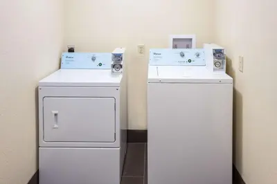 two washers and a refrigerator in a room at Quality Inn Charleston South in Charleston