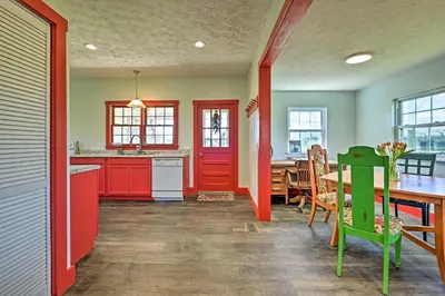 a kitchen with red and green cabinets and a table at Renovated KY Farmhouse Retreat with Pasture Views! in Wallingford