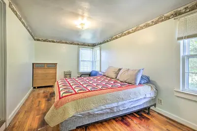 a bedroom with a bed and two windows at Renovated KY Farmhouse Retreat with Pasture Views! in Wallingford