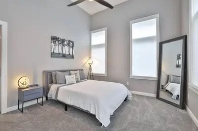 a bedroom with a large bed and a mirror at **NEW mOdernLUX best OTR condo *Park ONsite** in Cincinnati