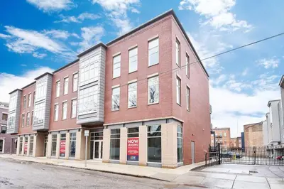 a large red brick building on a city street at **NEW mOdernLUX best OTR condo *Park ONsite** in Cincinnati