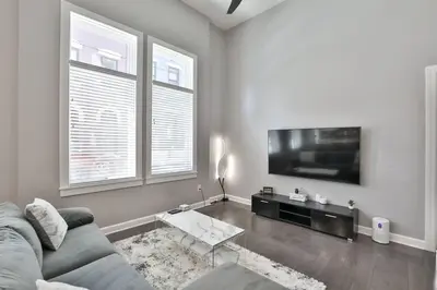 a living room with a couch and a flat screen tv at **NEW mOdernLUX best OTR condo *Park ONsite** in Cincinnati