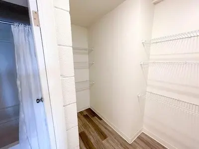 a walk in closet with white walls and a door at Sleepover Downtown Cincinnati 1BD 1BA Apartments in Cincinnati