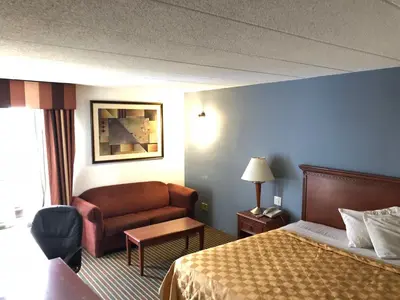 a hotel room with a bed and a couch at Knights Inn Dayton by Miller Lane in Dayton