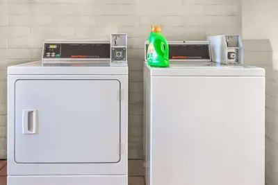 two white refrigerators with a soda bottle on top of them at Knights Inn Dayton by Miller Lane in Dayton