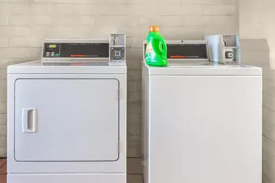 two white refrigerators with a soda bottle on top of them at Knights Inn Dayton by Miller Lane in Dayton