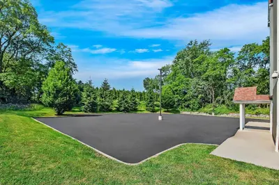an empty basketball court in a park with trees at Quality Inn & Suites in Washington