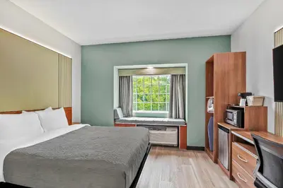 a hotel room with a bed and a window at Quality Inn & Suites in Washington