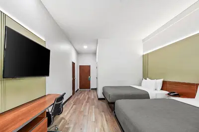 a hotel room with two beds and a flat screen tv at Quality Inn & Suites in Washington