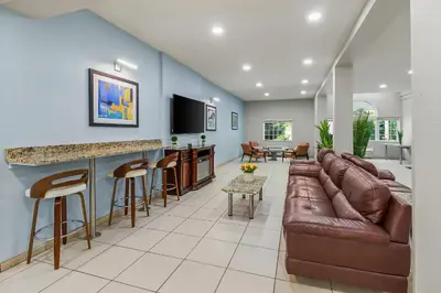 a living room with a couch and a bar at Quality Inn & Suites in Washington