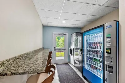 a waiting room with two refrigerators and a soda machine at Quality Inn & Suites in Washington