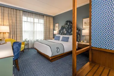 a hotel room with a bed and a desk at The Bradley in Fort Wayne