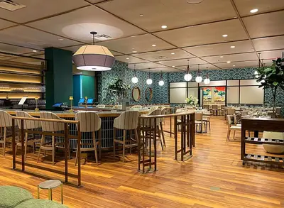 a restaurant with tables and chairs in a room at The Bradley in Fort Wayne