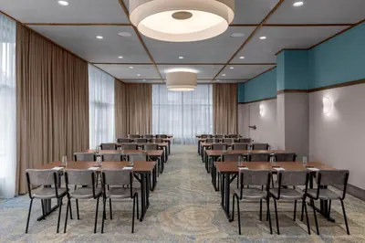 a conference room with tables and chairs in it at The Bradley in Fort Wayne