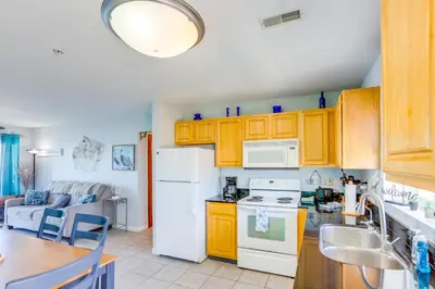 a kitchen with yellow cabinets and a white refrigerator at Cozy Middle Bass Island Getaway On Lake Eerie! in Put-in-Bay