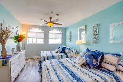 two beds in a bedroom with blue walls at Cozy Middle Bass Island Getaway On Lake Eerie! in Put-in-Bay