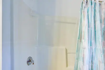 a shower curtain in a bathroom next to a tub at Cozy Middle Bass Island Getaway On Lake Eerie! in Put-in-Bay