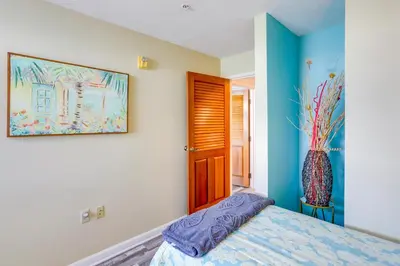 a bedroom with a bed and a painting on the wall at Cozy Middle Bass Island Getaway On Lake Eerie! in Put-in-Bay