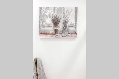 a painting of a vase with flowers in a window at Newly Renovated(6A) OSU/ExpoCenter Near EVERYTHING! in Columbus