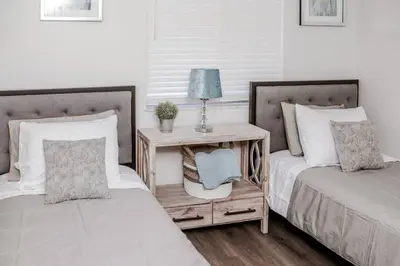 two beds sitting next to each other in a bedroom at Newly Renovated(6A) OSU/ExpoCenter Near EVERYTHING! in Columbus