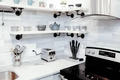 a kitchen with white walls and shelves on the wall at Newly Renovated(6A) OSU/ExpoCenter Near EVERYTHING! in Columbus