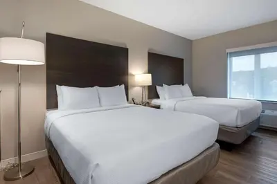 a hotel room with two beds and a window at Comfort Suites Cincinnati University - Downtown in Cincinnati