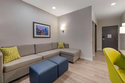 a living room with a couch and a chair at Comfort Suites Cincinnati University - Downtown in Cincinnati