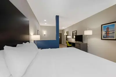 a large white bed in a hotel room at Comfort Suites Cincinnati University - Downtown in Cincinnati