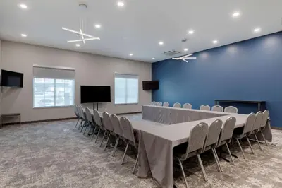 a conference room with a long table and chairs at Comfort Suites Cincinnati University - Downtown in Cincinnati