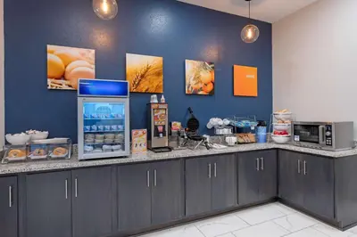 a kitchen with a counter with a microwave and a refrigerator at Comfort Suites Cincinnati University - Downtown in Cincinnati