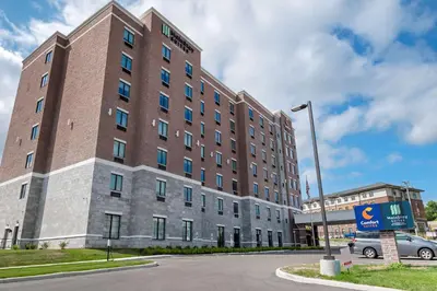a large brick building on the corner of a street at Comfort Suites Cincinnati University - Downtown in Cincinnati