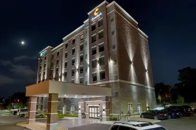 a hotel building at night with a parking lot at MainStay Suites Cincinnati University - Uptown in Cincinnati