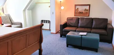 a living room with a couch and a table at Berlin Heritage Inn in Berlin
