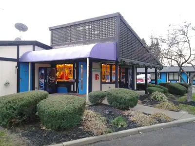 a building with a purple awning in front at Xenia Country Inn in Xenia