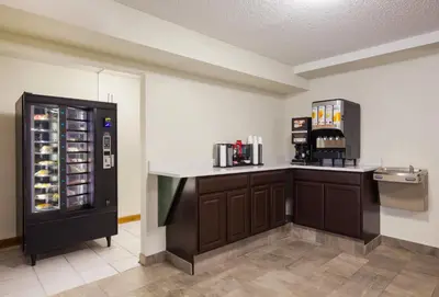 a kitchen with a counter and a refrigerator at Red Roof Inn Lawrenceburg in Lawrenceburg