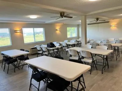 a classroom with tables and chairs in a room at Red Roof Inn Lawrenceburg in Lawrenceburg